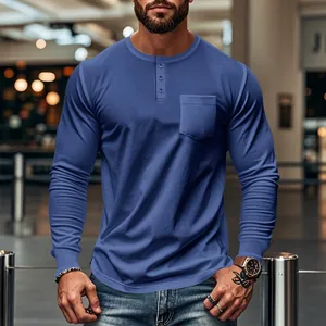 Detail of blue long-sleeve Henley shirt for men with chest pocket and buttons.