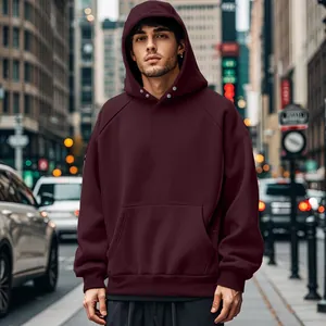 Close-up of a men's burgundy fleece hoodie with kangaroo pocket in an urban city street