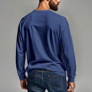 Back view of a men's blue slim fit long sleeve crew neck t-shirt in a studio setting