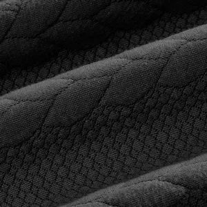 Macro shot of black heavy sweatshirt fabric with intricate diamond jacquard pattern texture.