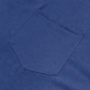 Detail view of the chest pocket and breathable blue fabric texture on a long sleeve shirt.