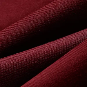 Macro detail of soft burgundy fleece fabric texture for men's winter hooded sweatshirt