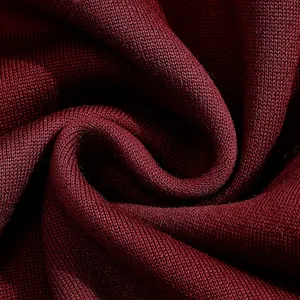 Macro shot of maroon knit fabric showing detailed weave texture and soft material finish