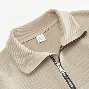 Detail view of khaki retro half-zip sweatshirt collar with jacquard texture and label