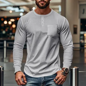 Detail of slim fit light grey long-sleeve Henley shirt for men with chest pocket.