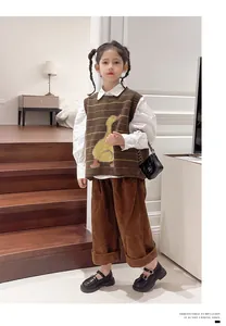 Young girl modeling classic black British style leather shoes with stylish metal buckles