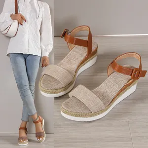 Detailed view of stylish women's summer platform wedge sandals with brown ankle strap