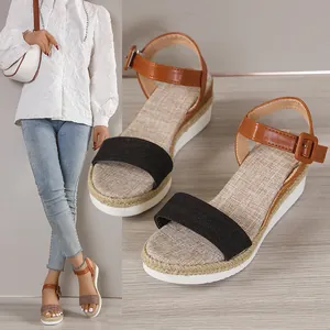 Detailed close-up of platform wedge sandals with brown ankle strap and black band