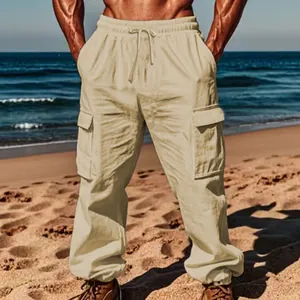 Close-up showing the fit of men's beige cotton linen cargo pants on a sunny beach