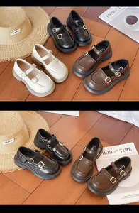 Macro view of classic Mary Jane children shoes in black, brown and beige colors.