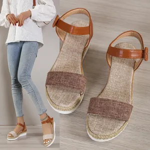 Detail of women's wedge sandals with linen texture and adjustable ankle strap