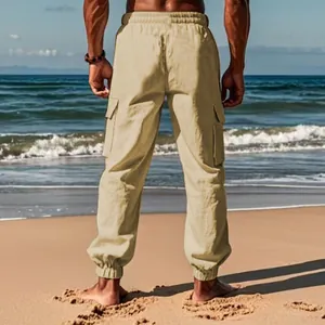 Detailed back view of khaki cotton linen men's cargo jogger pants on a sunny beach