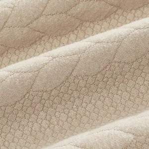 Macro close-up view showing the textured jacquard fabric of a heavyweight sweatshirt