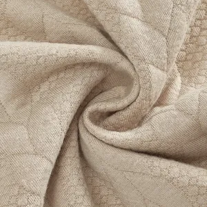 Close-up detail of premium heavyweight jacquard knit fabric with vintage texture