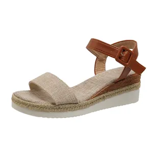 Side view of women's wedge platform sandals with brown ankle strap and linen band.