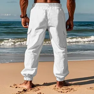 Back view of men's white breathable cotton linen cargo joggers on a sunny beach