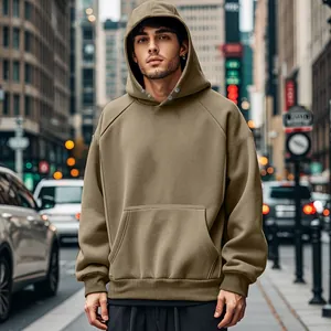 Front view of men's khaki oversized fleece hoodie on model in urban street setting