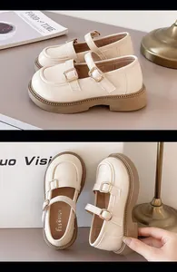 Detailed view of British style girls cream Mary Jane shoes with double buckle straps