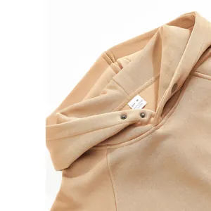 Detailed macro view of tan men's winter fleece hoodie collar and soft fabric texture