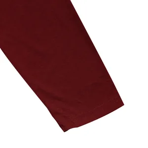Detailed macro view of the double-stitched cuff on a burgundy men's slim fit long sleeve t-shirt