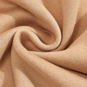 Macro detail shot showing the soft brown knitted fabric texture of a men's hoodie