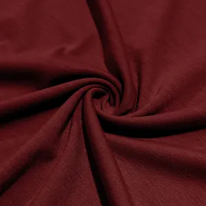 Close-up detail of breathable maroon knit fabric for men's slim fit long-sleeve t-shirt