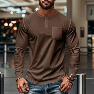 Macro detail of men's brown slim-fit long-sleeve Henley t-shirt with a chest pocket.