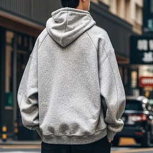 Back view of a men's grey oversized fleece-lined hooded sweatshirt in urban street style.