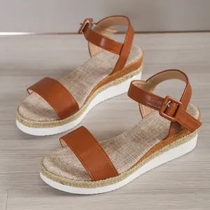Detailed side view of brown platform wedge sandals featuring linen texture insoles