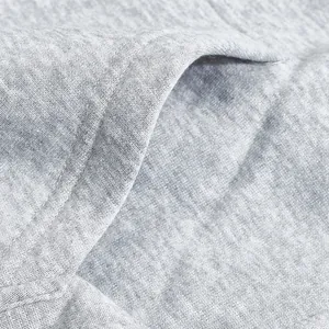 Close-up macro shot showing grey heather fleece hoodie fabric texture and pocket stitching