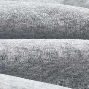 Macro detail view of soft grey fleece knitted fabric texture for men's winter hoodie