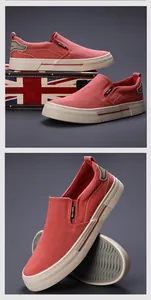 Detail view of red men's canvas slip-on shoes with comfortable flat rubber soles.