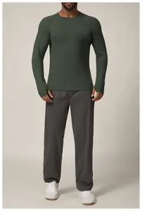 Detail view of a slim fit men's athletic long sleeve top in dark green for running and gym workouts