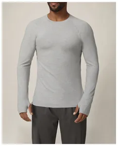 Detailed view of men's grey performance sports shirt featuring thumbholes on cuffs.