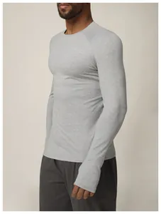 Close-up side view of men's slim fit grey long sleeve quick-dry athletic performance top