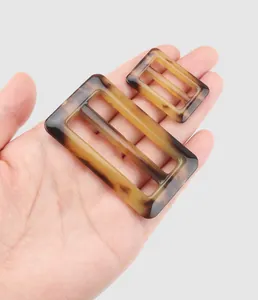 Detail of tortoiseshell urea resin belt buckles for high-end workwear coats and jackets
