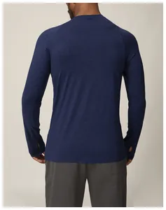 Back view of men's navy blue quick-dry athletic long sleeve shirt with thumbhole detail.