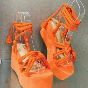 Vibrant orange platform wedge sandals with cross rope lace-up straps and open toe