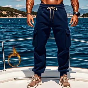 Close-up of men's navy blue fleece-lined cargo joggers with multi-pockets on a luxury yacht