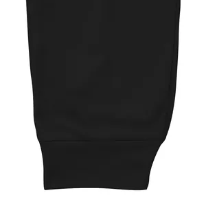 Detailed close-up view of the elastic ribbed cuff on black athletic joggers for men