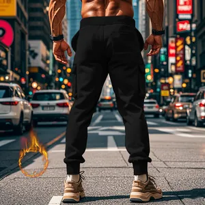 Back view of men's fleece-lined black cargo joggers on a muscular model in city street.