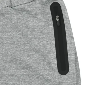 Detailed close-up view of the black zipper pocket on grey athletic sports pants for men