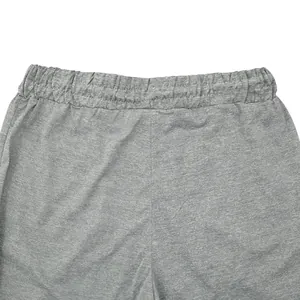 Detailed close-up showing the elastic waistband of grey men's athletic jogger pants