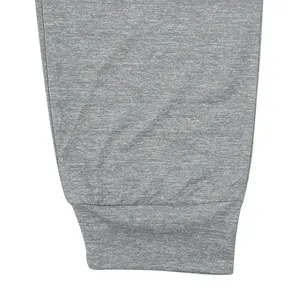 Macro view showing the elastic ribbed cuff detail of grey men's fitness sports jogger pants