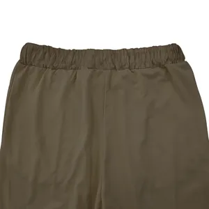 Detailed view of elastic waistband on men's khaki solid color athletic sports pants