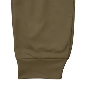 Detailed close-up of the elastic ribbed ankle cuff on men's olive green sports pants
