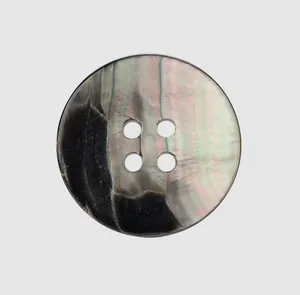 Close-up detail of a high-end four-hole natural shell button with iridescent texture
