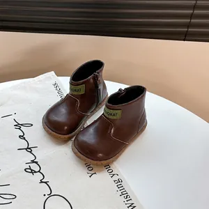 Classic brown toddler leather boots with soft sole and side zipper closure.