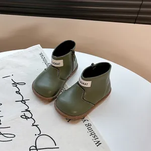 Close-up of olive green soft-sole toddler boots with high-top design and side zipper.