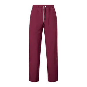 Close-up of maroon men's trousers featuring a white drawstring and elastic waistband.